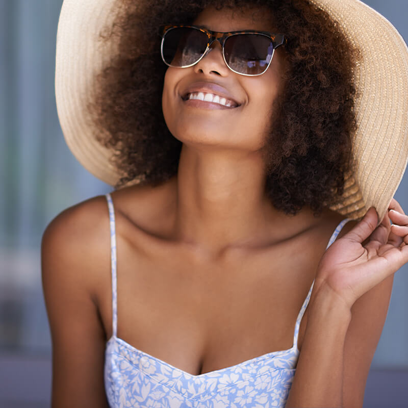 Beautiful woman in a sun hat and sun dress